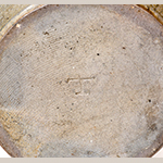 Fig. 21: Detail of impressed “T” on base of the storage jar illustrated in Fig. 20. Photo courtesy Crocker Farm Auctions, Sparks, MD.