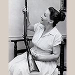 Fig. 2 Theo Taliaferro with a long rifle, ca. 1965. Old Salem Museums and Gardens Photograph Collection.