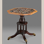 Fig. 3: Chess table; tabletop: unknown artist, 1809, Rome, Italy; base: attributed to John C. Bowie (1786–1851) and/or Walter Bowie (1790–1853), 1820, Port Royal, VA. Inscribed in ink on a torn paper label adhered to top of base: “J Bernar…/ Gay… ." Mahogany and black walnut with brass, slate, marble, limestone, lapis lazuli, malachite, and other stones; HOA: 27-1/8", WOA: 24-3/4”, DOA: 24-7/8”. Collection of Colonial Williamsburg Foundation, Acc. 2015-341, Museum Purchase and TIF Foundation in memory of Michele Iverson.