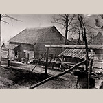 Fig. 12 Lot 81 by photographer E.F. Small; Salem, NC; 1882. Albumen print; HOA 5 1/8”; WOA 7 3/8”. Collection of Old Salem Museums & Gardens, Acc. 4241.235. The building to the left in this photograph once housed men from Bethabara and Bethania who came to construct the Moravians’ central town of Salem. Later, it became a pottery shop for Heinrich Schaffner and Daniel Krause. Note the ceramic pots sitting on wooden planks. Family lore says that Davie County’s William Franklin James was a Moravian potter. Records indicate that he was not Moravian, but he perhaps worked here as a journeyman potter as his pottery is frequently misidentified as Moravian-made.