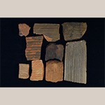 Fig. 43 Kiln tiles by an unknown maker; Huntsville, Yadkin County, NC; ca. nineteenth century. Unglazed earthenware. Private collection. Photograph by the author. These distinctively grooved tiles are similar to examples found on a nearby Davie County site and other North Carolina and Tennessee sites associated with Vestal family potters. They were probably used to separate stacked pottery during firing.