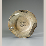 Fig. 17: Mold for Queensware plates (reverse), inscribed “RC” for the shop of Rudolph Christ, 1770–1785, Salem, NC. Plaster of Paris; DIA: 8”. Old Salem Museums & Gardens, Wachovia Historical Society Collection, Acc. M-248. Photograph by Gavin Ashworth.