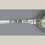 Fig. 15 Detail of Elizabeth Tookey’s mark on tablespoon illustrated in Figure 14. Some Tookey pieces show her adapted mark that utilized the lozenge shape to signify her status as a widow, but the Skelton tablespoons indicate she continued using her mark even after James Tookey’s death. The pellet between “E” and “T” is difficult to decipher in this example.