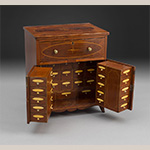 Fig. 9: Apothecary Cabinet or Chest attributed to James McAlester; Goochland or Louisa County, VA; 1800-1815. Cherry, mahogany, yellow pine, light and dark wood, mother of pearl, and bone; HOA 21-¼"; WOA 18-3/8”; DOA 13-¼". The Colonial Williamsburg Foundation. Museum Purchase, Acc. 1978-72.