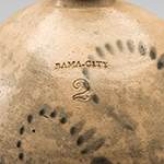 Fig. 3: Detail of "BAMA-CITY" stamped on shoulder of the jug illustrated in Figure 1.