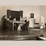 Fig. 79: Members of Hopewell-Centre Meeting in a historical reenactment during a benefit performance for the Civic League Milk Fund; unknown photographer, ca.1930. The chair in the left foreground with the broken upper slat might be the same chair recorded in MESDA Object Database file S-10679. This chair descended in the Lupton family of Apple Pie Ridge north of Winchester and came from the same house as the objects illustrated in Figs. 111, 112, and 114. Photograph courtesy Barbara Harner Suhay.
